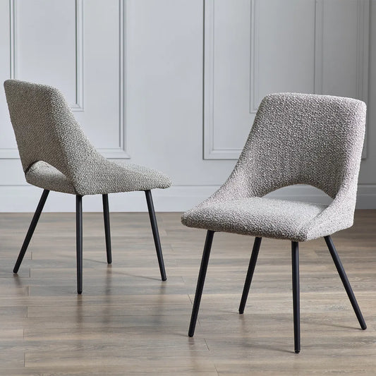 Shop the Iris Boucle Dining Chairs, upholstered in rich grey boucle and supported by black tapered legs, bring a touch of vintage-inspired glamour to any setting. Available today from www.nobleandnook.co.uk