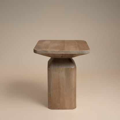 Wooden side table with a square top and cylindrical base on a beige background