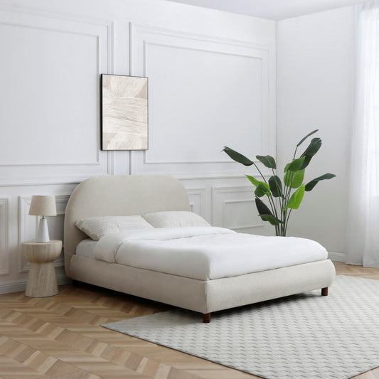 Modern bedroom with a white bed, side table, and plant.