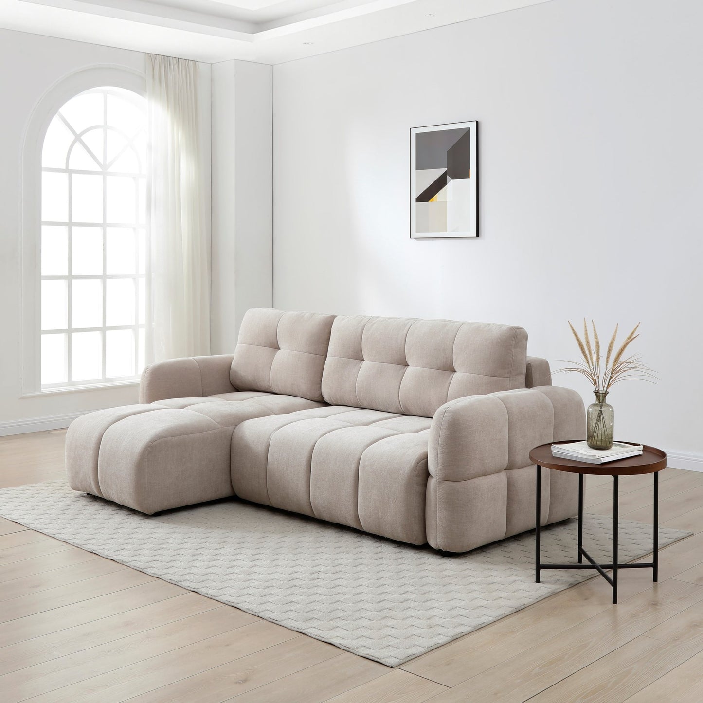 Beige sectional sofa in a modern living room with a side table and decorative elements.