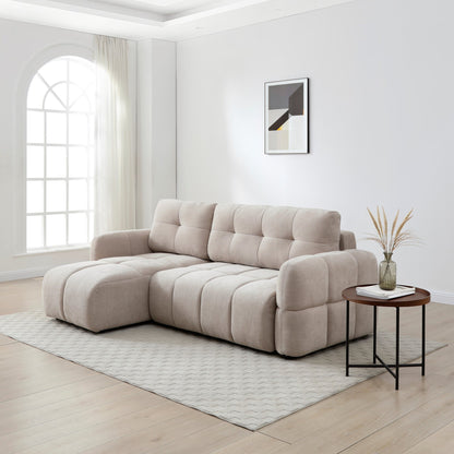 Beige sectional sofa in a modern living room with a side table and decorative elements.