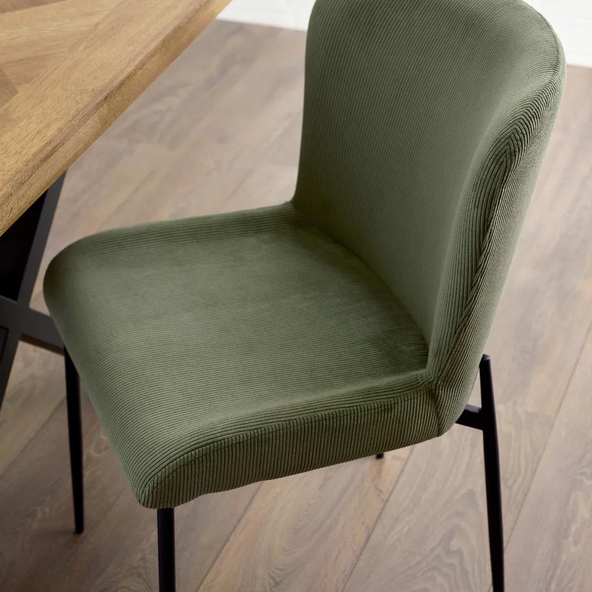 Shop the Leonie Dining Chair in green velvet and bring a sophisticated statement to your dining space. Featuring a plush, curved design and slender black legs. Shop online today at www.nobleandnook.co.uk