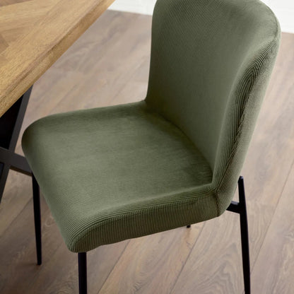 Shop the Leonie Dining Chair in green velvet and bring a sophisticated statement to your dining space. Featuring a plush, curved design and slender black legs. Shop online today at www.nobleandnook.co.uk