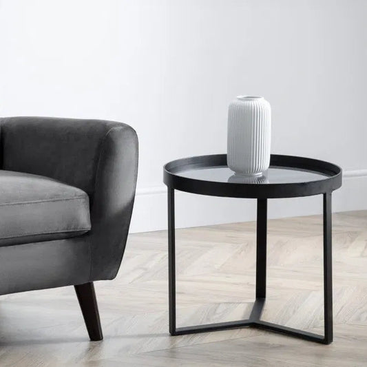 Shop the Soho Side Table, a perfect blend of sophistication, featuring a geometric black metal base and a smoked tempered glass top. Shop Online today at www.nobleandnook.co.uk