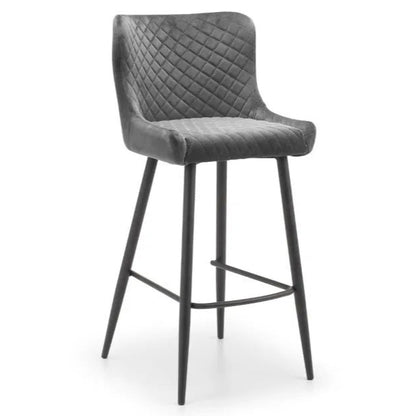 Bring a touch of luxury to your dining space with the Luxe Grey Velvet Bar Stool with sleek black metal legs. Ideal for kitchen islands, home bars, or high counters. Shop online today at www.nobleandnook.co.uk