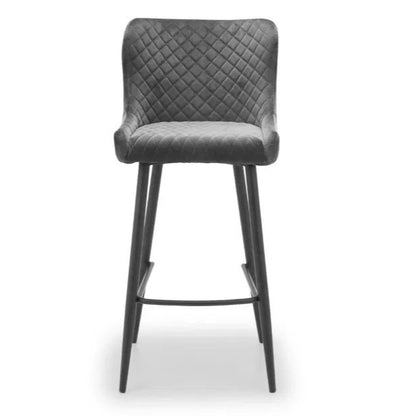Bring a touch of luxury to your dining space with the Luxe Grey Velvet Bar Stool with sleek black metal legs. Ideal for kitchen islands, home bars, or high counters. Shop online today at www.nobleandnook.co.uk