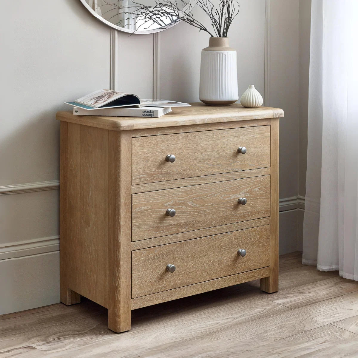 Wooden dresser with three drawers in a room setting