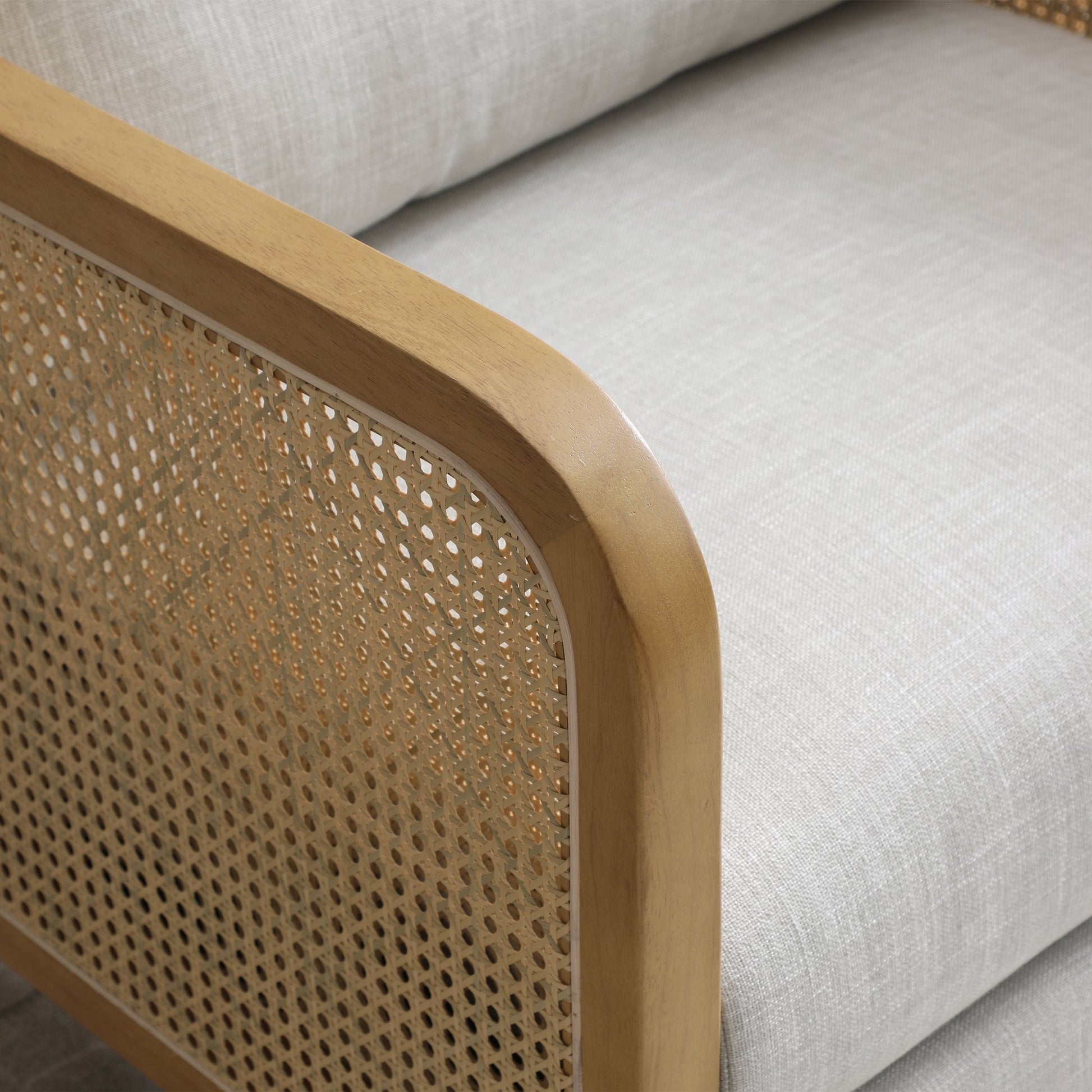Shop the Mabel Rattan Accent Chair, a unique piece featuring a padded back and seat adorned with a bolster cushion, all resting on a stained wooden frame. Shop online now at www.nobleandnook.co.uk