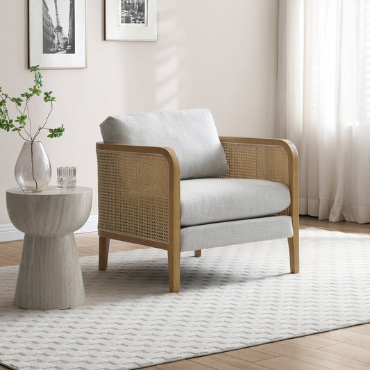 Shop the Mabel Rattan Accent Chair, a unique piece featuring a padded back and seat adorned with a bolster cushion, all resting on a stained wooden frame. Shop online now at www.nobleandnook.co.uk