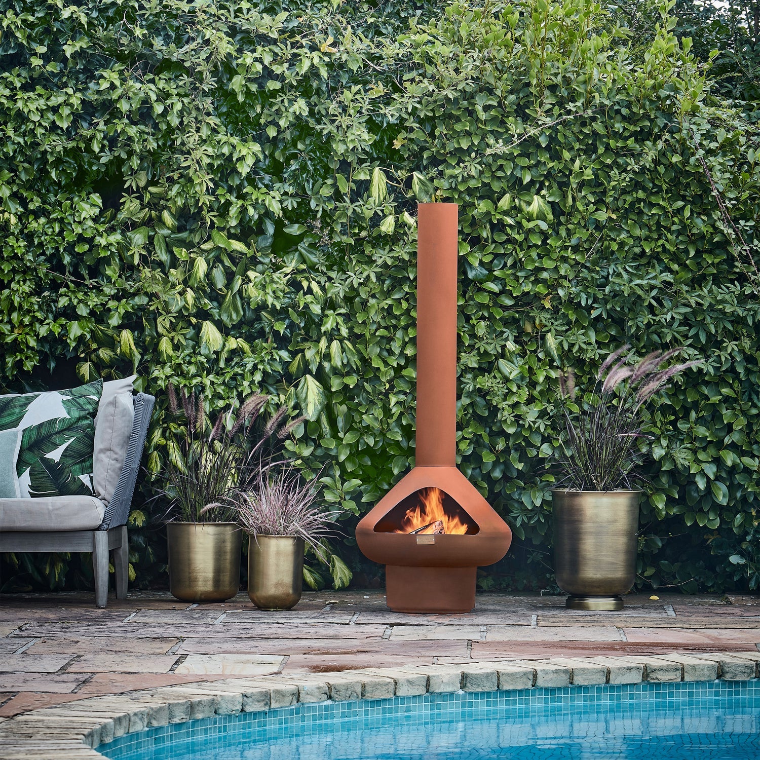 The Outdoor Fornax Fireplace provides a warm and cosy atmosphere, perfect for extending outdoor time during chilly nights. Shop online now at www.nobleandnook.co.uk