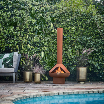 The Outdoor Fornax Fireplace provides a warm and cosy atmosphere, perfect for extending outdoor time during chilly nights. Shop online now at www.nobleandnook.co.uk