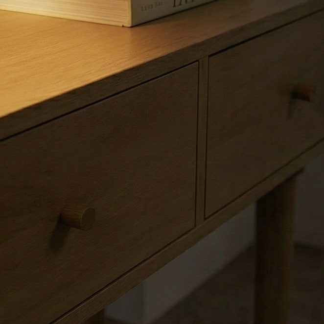 Wooden dresser with two drawers and a book on top