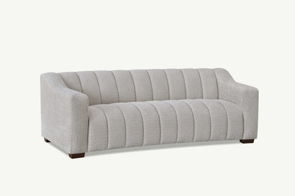 Indulge in luxury with the Aluxo Astoria 3 Seater Sofa in Oatmeal Boucle Fabric. An exquisite piece featuring deep channel stitching and adorned with a soft and alluring boucle fabric in a stunning Oatmeal hue. Shop online today at www.nobleandnook.co.uk