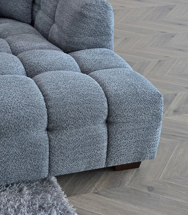 Shop the Tribeca Corner Sofa, featuring deep channel stitching and upholstered in a stunning iron boucle fabric. A modern twist on the classic Chesterfield design. Shop online today at www.nobleandnook.co.uk