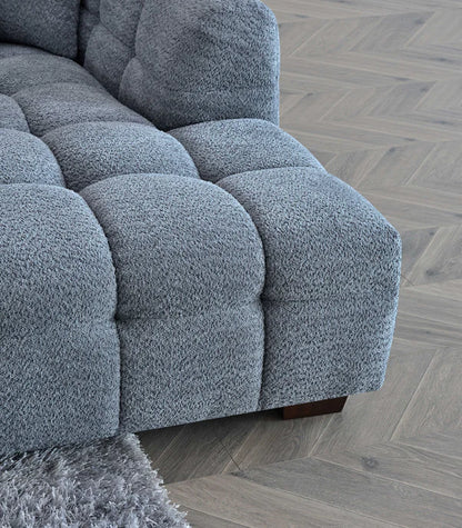 Shop the Tribeca Corner Sofa, featuring deep channel stitching and upholstered in a stunning iron boucle fabric. A modern twist on the classic Chesterfield design. Shop online today at www.nobleandnook.co.uk
