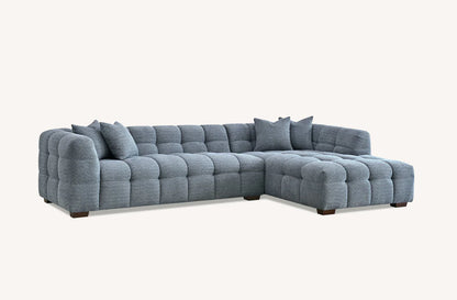 Shop the Tribeca Corner Sofa, featuring deep channel stitching and upholstered in a stunning iron boucle fabric. A modern twist on the classic Chesterfield design. Shop online today at www.nobleandnook.co.uk