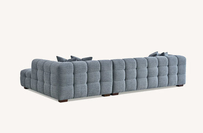 Shop the Tribeca Corner Sofa, featuring deep channel stitching and upholstered in a stunning iron boucle fabric. A modern twist on the classic Chesterfield design. Shop online today at www.nobleandnook.co.uk