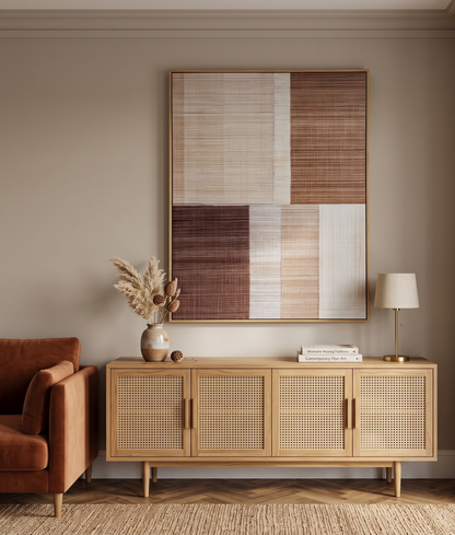 Modern living room with wooden sideboard, armchair, and abstract art on wall.