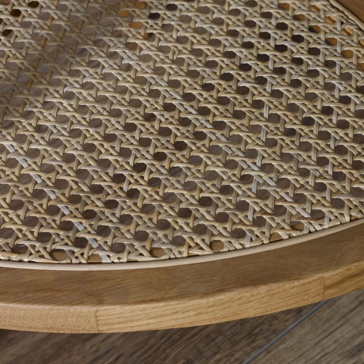 The Vera Side three-legged Table, featuring a rattan-inspired shelf and a warm natural wood finish.  Perfect for smaller spaces. Available at www.nobleandnook.co.uk