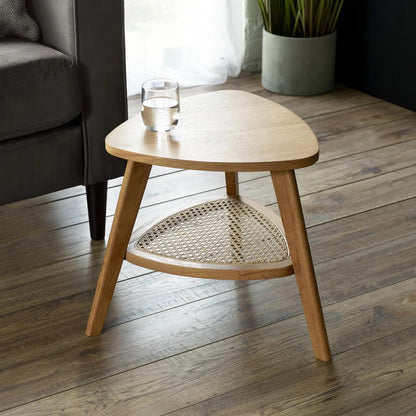 The Vera Side three-legged Table, featuring a rattan-inspired shelf and a warm natural wood finish.  Perfect for smaller spaces. Available at www.nobleandnook.co.uk