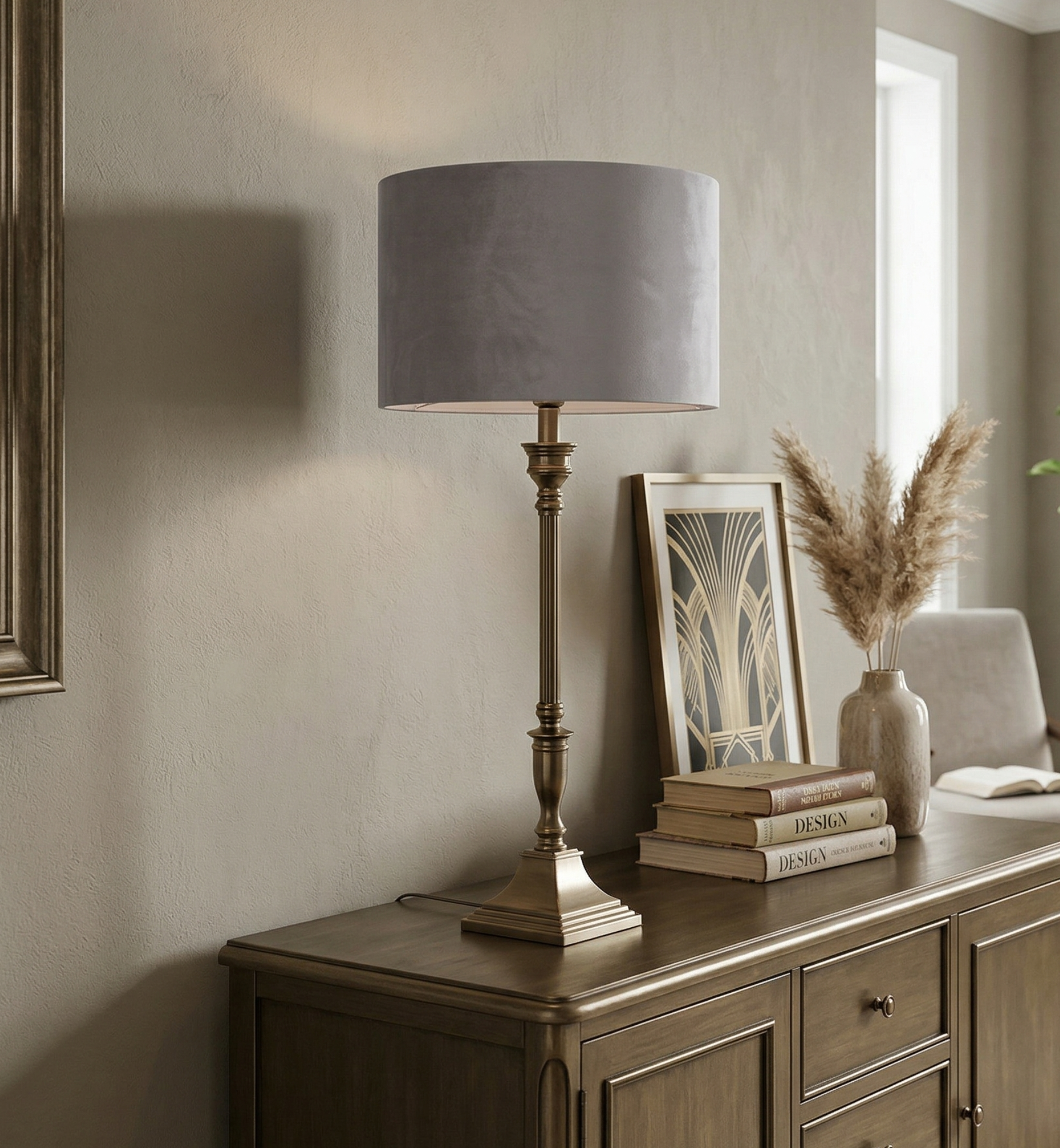 Decorative setting with a lamp, books, and a plant on a wooden sideboard in a room.