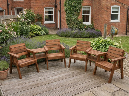 Wooden garden furniture set on a wooden deck in front of a brick building with garden plants.