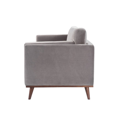 Shop the Mickey 3 Seat Sofa in a fashionable grey velvet hue with tapered walnut legs. This is a contemporary masterpiece. Shop online today at www.nobleandnook.co.uk
