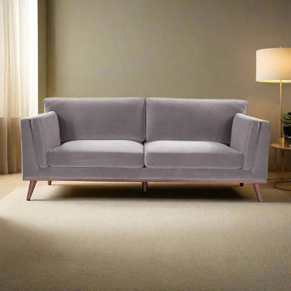 Shop the Mickey 3 Seat Sofa in a fashionable grey velvet hue with tapered walnut legs. This is a contemporary masterpiece. Shop online today at www.nobleandnook.co.uk