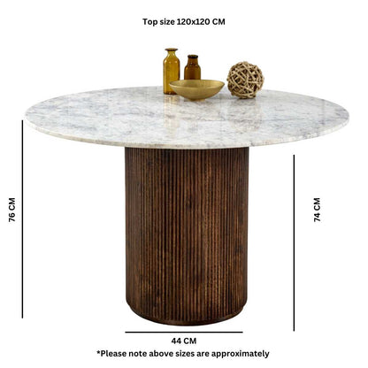 Luxurious white marble top with a sculptural base crafted from 100% solid mango wood for textural depth. Handmade in India using eco-friendly materials. H76×W120×D120cm. www.nobleandnook.co.uk